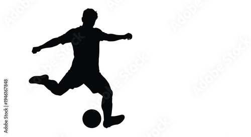 Silhouette of a soccer player powerfully kicking a ball during a competitive match moment