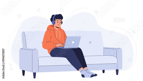 Young Man with Headphones Using Laptop on Sofa, Relaxed Lifestyle