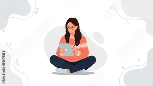 Young Woman Freelancer Working on Tablet Computer with Stylus, Sitting Cross-legged