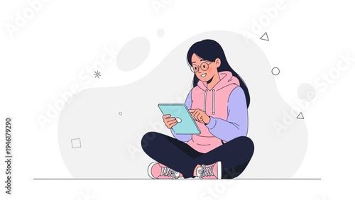 Young Woman Using Tablet Computer, Sitting Cross-legged, Wearing Hoodie