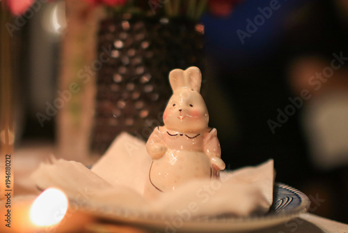 Photos Cute Rabbit ceramic paperweight on tissue at dinner table creating cozy and luxury atmosphere