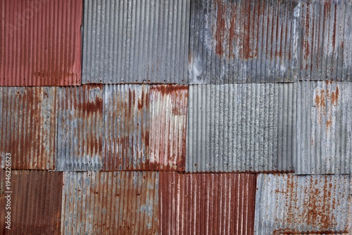 Artistic of old and rusty zinc sheet wall. Vintage style metal sheet roof texture. Pattern of old metal sheet. Rusting metal or siding. Corrosion of galvanized. Background and texture in retro concept