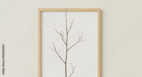 Minimalist Wooden Frame with Bare Twig on Beige Background