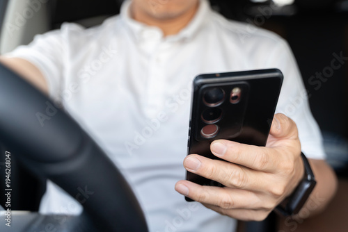 Driver holding smartphone in car with mobile communication and digital lifestyle concept