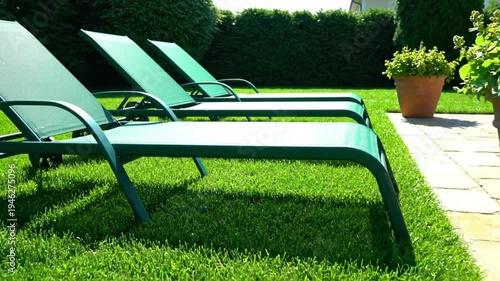 Wallpaper Mural Tranquil outdoor scene with three green lawn chairs and potted plants on a sunny day in a lush garden Torontodigital.ca