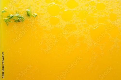 Rich yellow Brazilian moqueca stew surface with green herbs