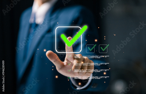 Business professional touching digital checklist interface with glowing green check mark icon. Concept of task completion, approval process, quality assurance, verification system, workflow management