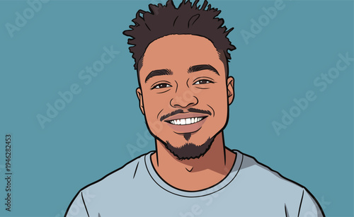 A young man smiles at the viewer while wearing a light blue shirt. He has short hair and a cheerful expression.