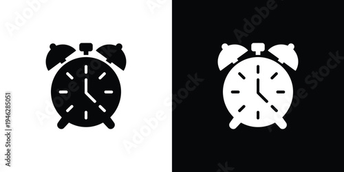Black and white alarm clock on split background symbol