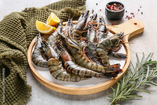 Board with fresh raw shrimp...