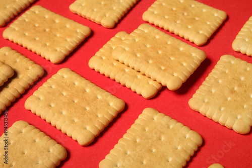 Tasty sweet cookies on red ...