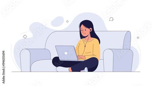 Young woman working on laptop while sitting cross-legged on sofa with headphones