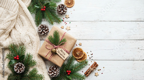 Christmas decorations with tree branches ribbons and ornaments on a wooden table for holiday celebration