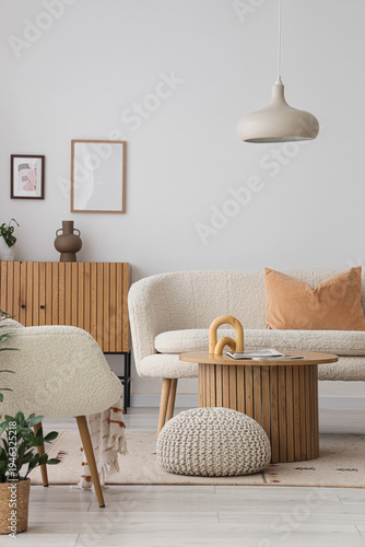 Interior of light living room with white sofa and lamp