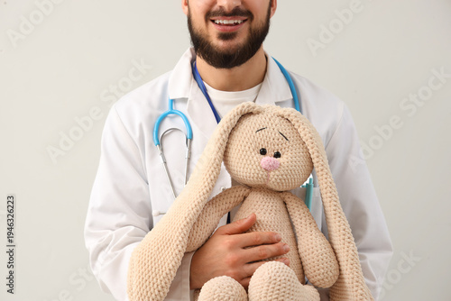 Male pediatrician with toy ...