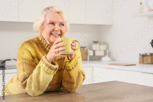 Happy elderly woman with cu...