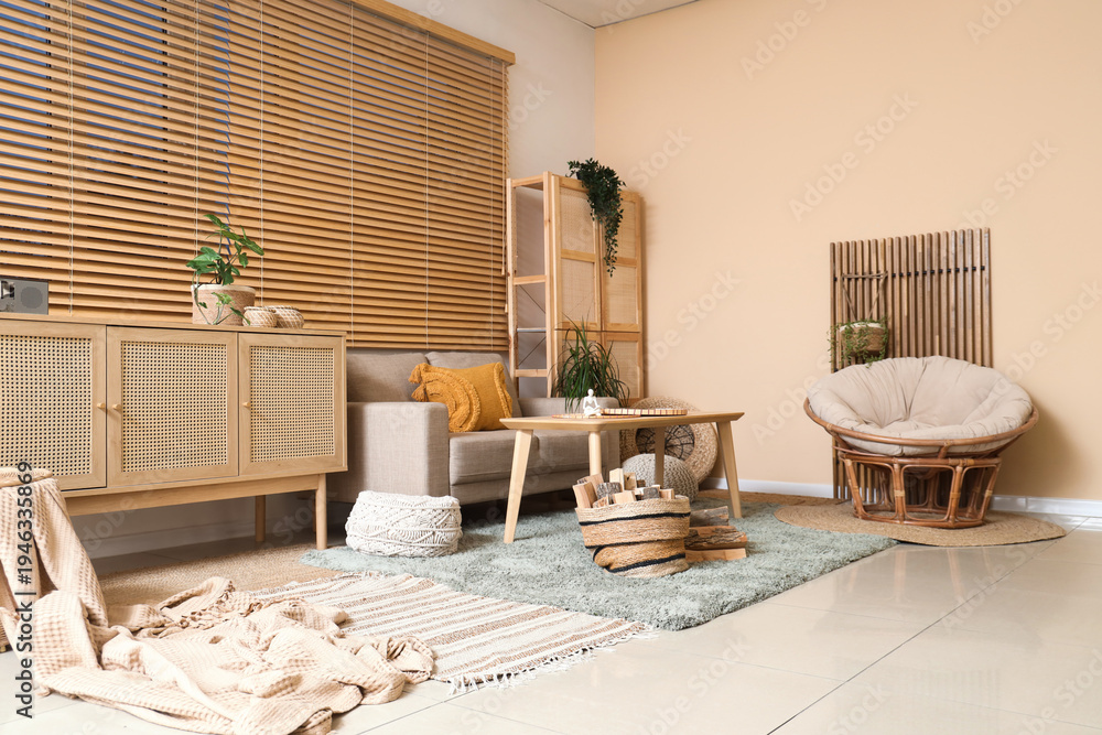 Fototapeta premium Interior of living room with sofa, armchair, coffee table, commode, closet and firewood near window