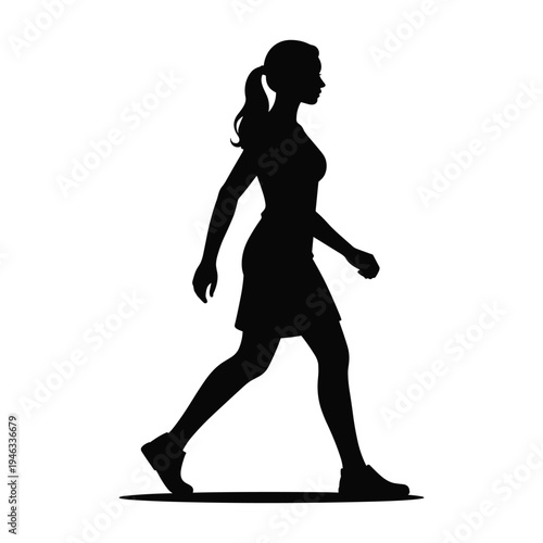 Confident woman walking with purpose in stylish outfit