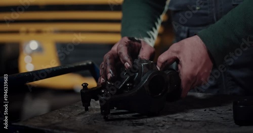 mechanic inspecting heavy duty engine rocker arm parts in workshop