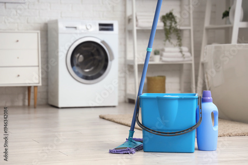 Mop with bucket of water an...