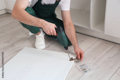 Male worker with drill asse...