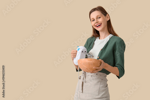 Young woman with mixer and ...