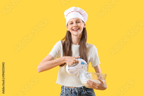 Female chef whipping dough ...