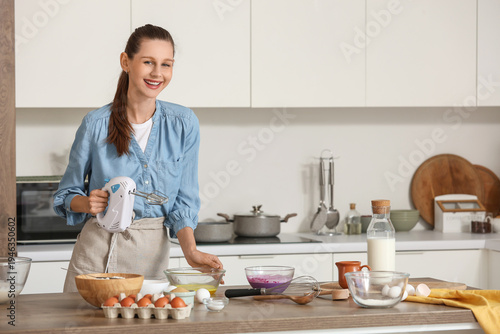 Young woman with mixer cook...