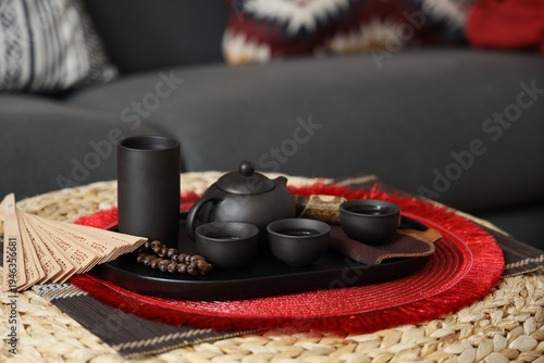 Asian tea set on table in l...