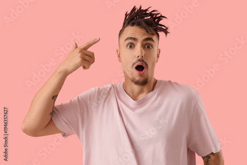 Shocked young man pointing ...