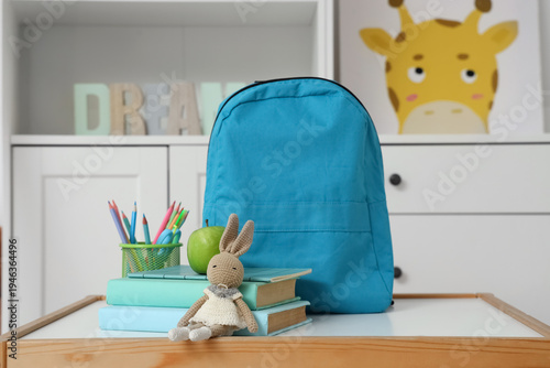 Blue backpack with toy, app...