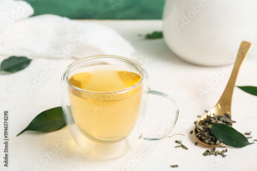Glass cup of hot green tea ...