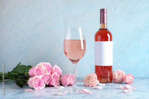 Glass and bottle of pink wi...