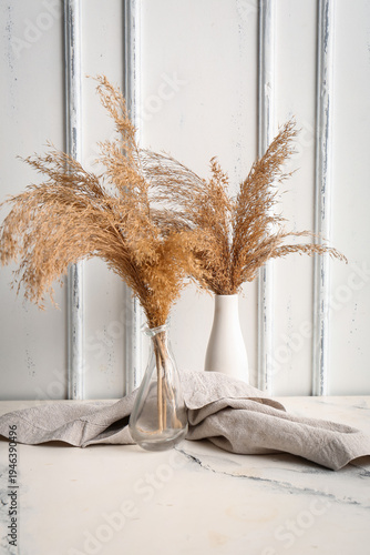 Vases with dry reeds and na...