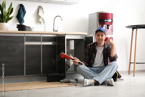 Male plumber with pipe wren...