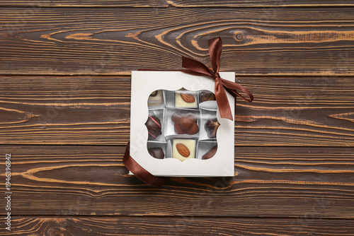 Box with tasty candies on w...