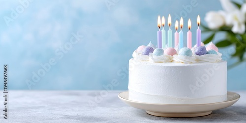 a birthday cake with colorful candles against a blue background.