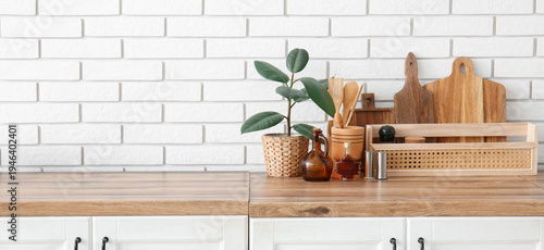 Plant with utensils on coun...