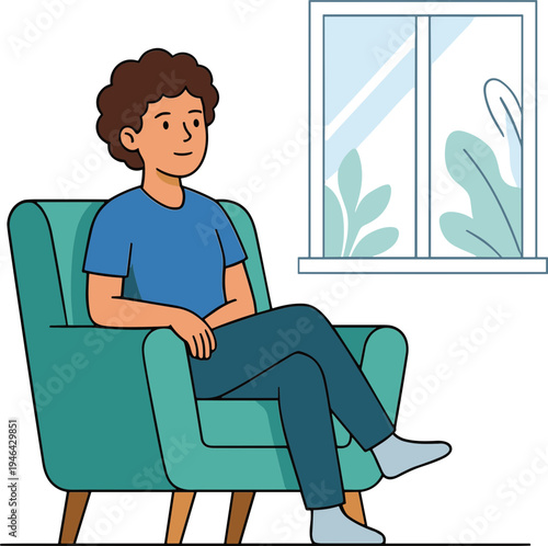 A man sits relaxed on a chair indoors by a window.