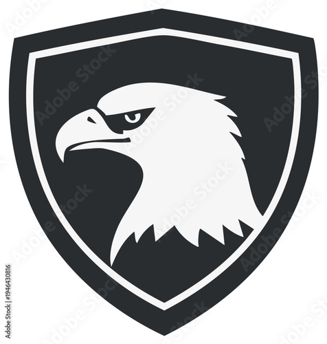 Bold eagle emblem within a shield, vector design for logos and badges, monochrome graphic representation of raptor head.