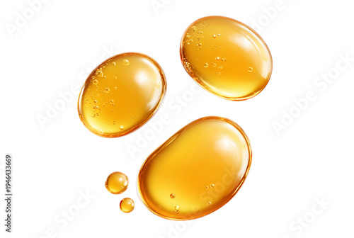Three golden oil droplets with bubbles on transparent background
