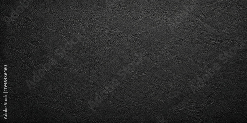 A dark grunge wallpaper features a rough black asphalt texture with a gray macro pattern on an old weathered surface for a textured material backdrop