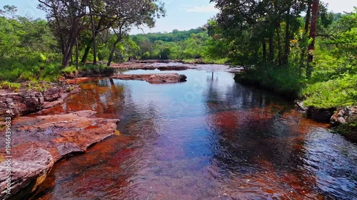 Wallpaper Mural Drone footage over Caño Sabana in Colombia shows a colorful river landscape flowing through dense tropical vegetation in the remote Guaviare region. Torontodigital.ca