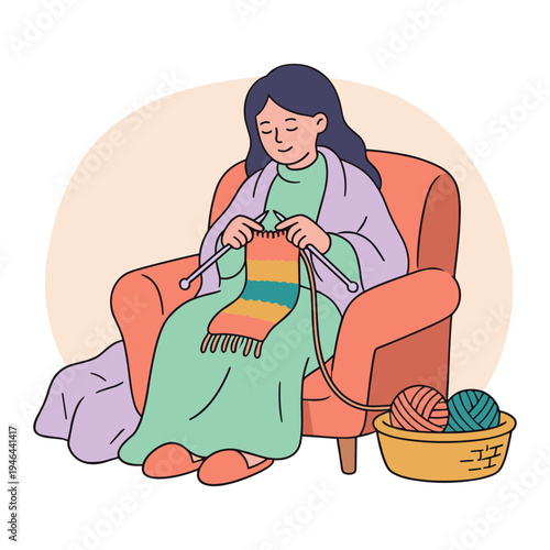 A woman sits in an armchair knitting a colorful scarf with yarn balls nearby.