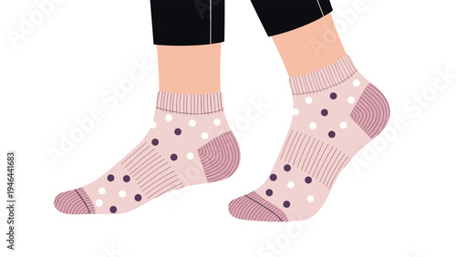 Close up view of a pair of pink ankle socks with a white and purple polka dot pattern being worn by a person on a white background.