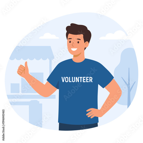 A smiling young man wearing a volunteer t-shirt gives a thumbs up outdoors.