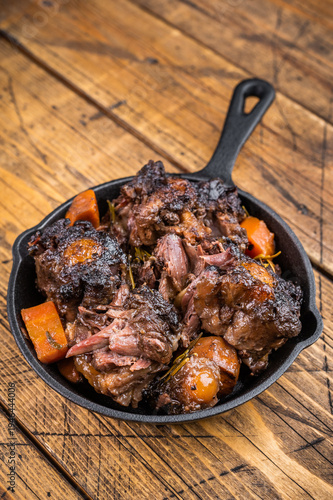 Quadro su tela Braised beef oxtail stew with carrots and rosemary in cast iron skillet on rusti