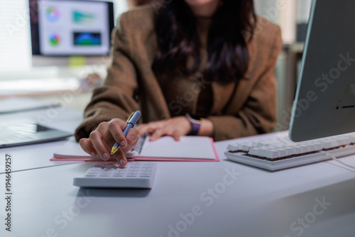 Person calculating expenses and managing personal finance