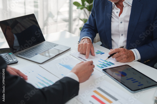 Business professionals analyzing financial report charts and data