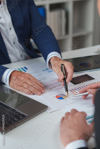 Business people analysing financial data charts together